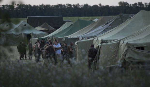 Ukrainian soldiers, who fled the conflict territory, spend their time at a tent camp near the Russia-Ukraine border just outside the village of Gukovo, Rostov-on-Don region, Southern Russia, on Monday, August 4, 2014. (AP Photo/Alexander Zemlianichenko)