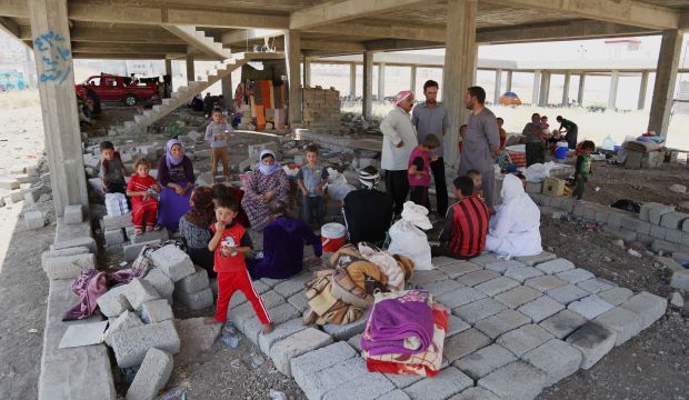 Displaced Yazidis find shelter in a half-finished building in Dohuk, Iraqi Kurdistan, on August 14, 2014. (AP Photo/ Khalid Mohammed)