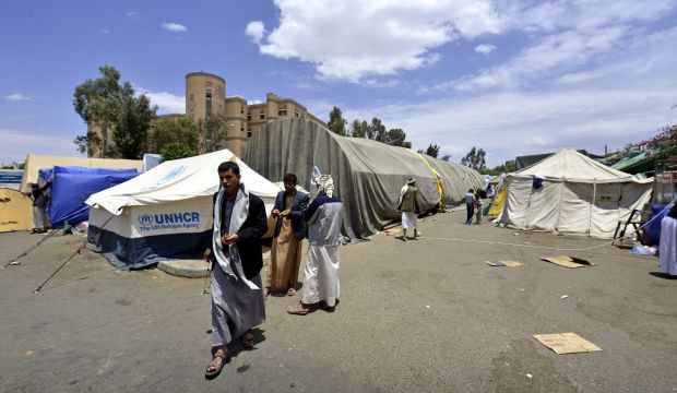 Followers of the Shi'ite Houthi movement walk through an anti-government protest camp a day after the UN Security Council condemned their actions, in Sanaa, Yemen, on August 30, 2014. (EPA/Yahya Arhab)