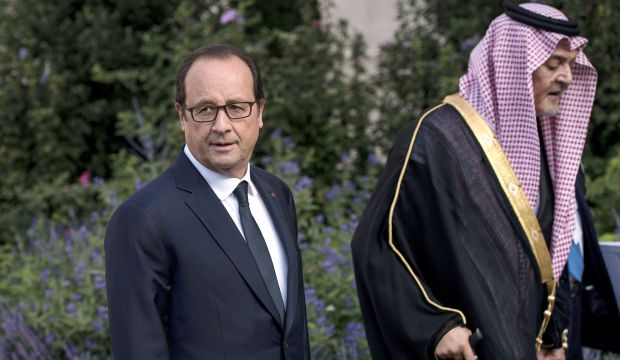 French President Francois Hollande (L) and Saudi Arabian Foreign Minister Prince Saud Al-Faisal (R) leave after a group photo at the International Conference on Peace and Security in Iraq on September 15, 2014 at the Quai dOrsay in Paris. (AFP PHOTO / Brendan SMIALOWSKI)