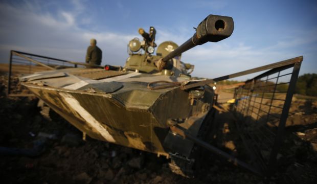 A Ukrainian serviceman is pictured next to an armored vehicle near the village of Debaltseve in eastern Ukraine September 21, 2014. (REUTERS/David Mdzinarishvili)