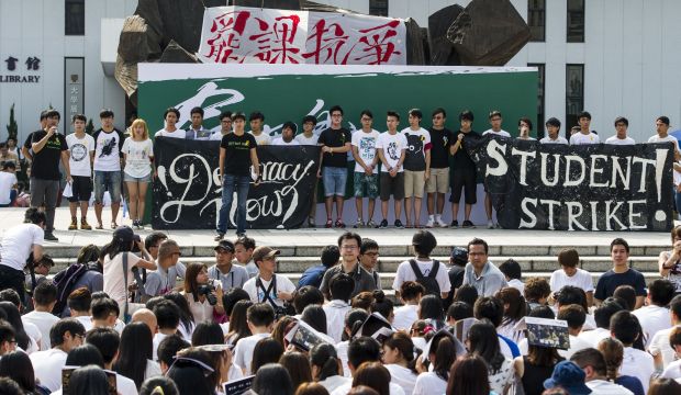 Students gather during a strike as a pro-democracy activist (L) speaks at the Chinese University of Hong Kong on September 22, 2014. (AFP PHOTO / XAUME OLLEROS)