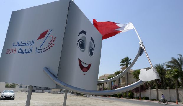 A metal sculpture of a ballot box holding the Bahraini flag, meant to encourage people to vote in the 2014 parliamentary and municipal elections, is seen on a side road in the affluent neighborhood of Saar north of Manama, Bahrain, on September 23, 2014. (EPA/Mazen Mahdi)