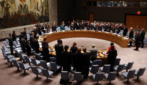 Delegates stand during a moment of silence in honor of victims of terrorism at a meeting of the United Nations Security Council regarding the threat of foreign terrorist fighters during the 69th session of the UN General Assembly at UN headquarters, Wednesday, September 24, 2014. (AP Photo/Jason DeCrow)