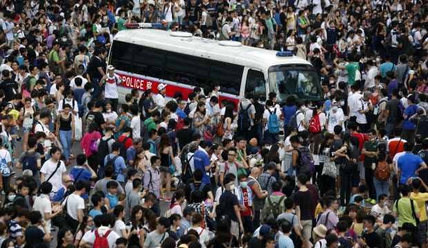 A police vehicle stands still as tens of thousands of protesters block the main street to the financial Central district outside the government headquarters in Hong Kong September 28, 2014. (REUTERS/Bobby Yip)