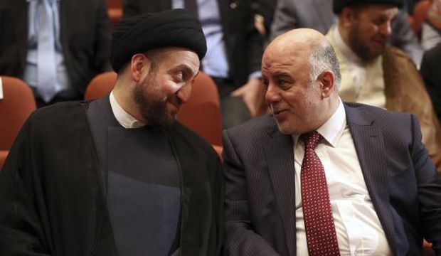 Iraq's new Prime Minister Haider Al-Abadi (R) and Ammar Al-Hakim, leader of the Islamic Supreme Council of Iraq (ISCI), meet during the session to approve the new government in Baghdad, Iraq, on September 8, 2014. (Reuters/Hadi Mizban/Pool)