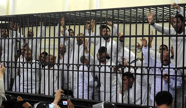 Supporters of the Muslim Brotherhood and ousted president Mohamed Mursi stand trial in a courtroom in Alexandria, Egypt, on March 29, 2014. (Reuters)
