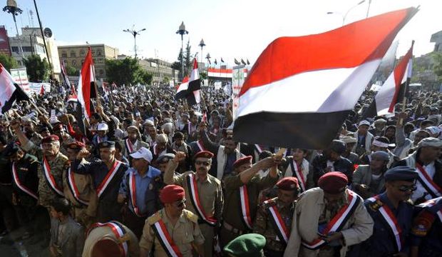 Supporters of the Shi’ite Houthi movement wave Yemeni flags as they celebrate in Sana'a, Yemen, on September 23, 2014. (EPA/Wadia Mohammed)