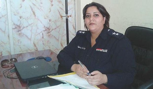 First Lt. Rasha Al-Tayar, Baghdad’s only female police officer, sits at her desk in her office at a police station in Baghdad, Iraq on September 8, 2014. (Asharq Al-Awsat)