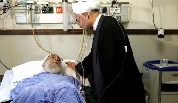 In this picture released by an official website of the office of the Iranian supreme leader, President Hassan Rouhani (R) visits Supreme Leader Ayatollah Ali Khamenei after his surgery in a hospital in Tehran, Iran, on Monday, September 8, 2014. (AP Photo/Office of the Iranian Supreme Leader)