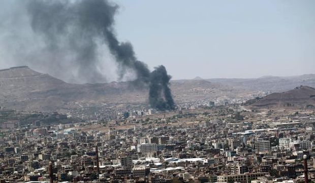 Smokes rise from a main army camp during clashes between Yemeni army troops and Shi’ite Houthi fighters in Sana'a, Yemen, on September 21, 2014. (EPA/Yahya Arhab)