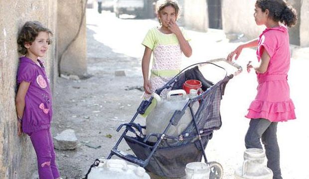 This undated file photo shows Syrian girls gathering water in Damascus, Syria. (Asharq Al-Awsat)