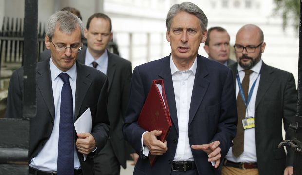 Britain's Secretary of State for Foreign and Commonwealth Affairs Philip Hammond (C) arrives for a meeting of the emergency response committee, Cobra, in Downing Street, London on September 14, 2014, following the beheading of British aid worker David Haines by ISIS militants. (AFP PHOTO/Cyril Villemain)