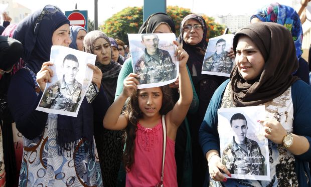Relatives of Lebanese soldiers, kidnapped by fighters believed to be linked to ISIS and the Al-Nusra Front, hold photos depicting the soldiers during a protest in front of the Lebanese government palace in Beirut, Lebanon, 04 September 2014. (EPA/Nabil Mouzner)