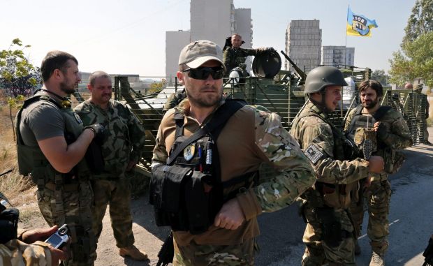 Soldiers of the Ukrainian self-defence battalion Azov take a break at a check point on a road in the eastern Ukrainian city of Mariupol Ukraine, 05 September 2014. (EPA/Natoly Maltsev)