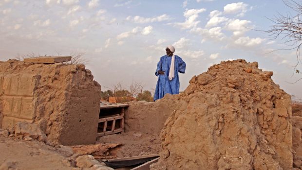 In this Friday, April 4, 2014, file photo, head mason Alassane Ramiya inspects the remains of tombs at a mausoleum after it was damaged in Timbuktu, Mali.
