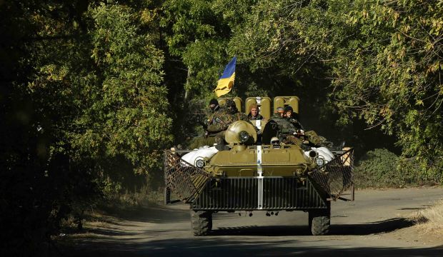 Ukrainian servicemen ride on an armored vehicle in the eastern Ukrainian town of Kramatorsk on September 20, 2014. (Reuters/David Mdzinarishvili)