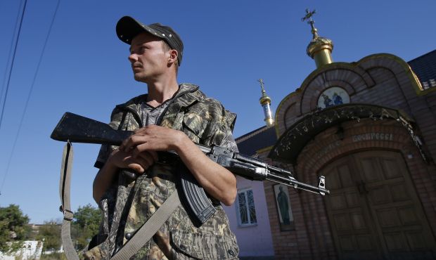 A pro-Russian separatist stands guard near an orthodox church in the eastern Ukrainian town of Ilovaysk September 5, 2014. (Reuters/Maxim Shemetov)