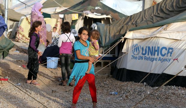 Displaced Iraqis forced to flee their homes ahead of gains made by Islamic State of Iraq and Syria (ISIS) militants in and around Mosul, shelter at the Bahrka Refugee camp, Erbil, northern Iraq, on September 19, 2014. (EPA/Mohamed Messara)