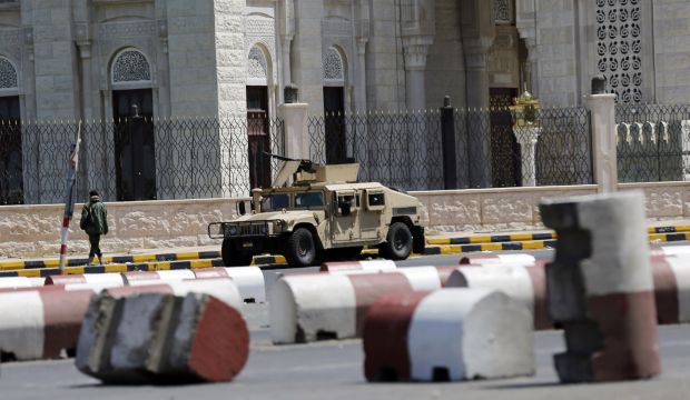 A road leading to the Presidential Palace is blocked with concrete barricades and a military vehicle in Sana'a, Yemen, on October 11, 2014. (Reuters/Khaled Abdullah)