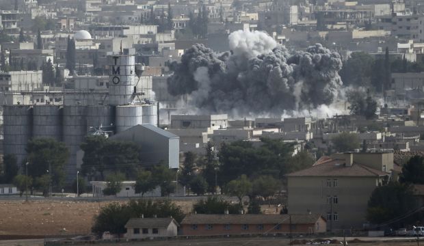 Smoke rises from the Syrian town of Kobani, seen from near the Mürşitpınar border crossing on the Turkish–Syrian border, on October 13, 2014. (Reuters/Umit Bektas)