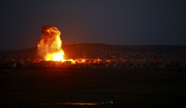 Smoke and flames rise over the Syrian town of Kobani after an air strike, as seen from the Turkish–Syrian border, on October 18, 2014. (Reuters/Kai Pfaffenbach)