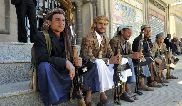 Gunmen loyal to the Houthi movement sit outside the headquarters of Sana'a province in Sana'a, Yemen, on October 19, 2014. (EPA/Yahya Arhab)