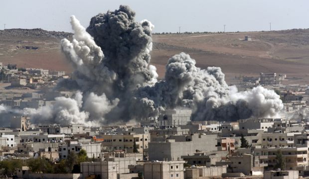 Thick smoke from an airstrike by the US-led coalition rises in Kobani, Syria, as seen from the Turkish-Syrian border, on October 22, 2014. (AP Photo/Lefteris Pitarakis)