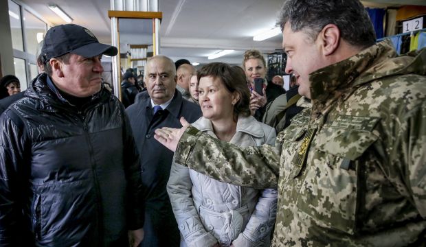 Ukraine's President Petro Poroshenko (R) greets local residents as he visits a polling station on the day of a parliamentary election in the town of Kramatorsk, eastern Ukraine, on October 26, 2014. (REUTERS/Ukrainian Presidential Press Service/Mikhail Palinchak/Handout via Reuters)