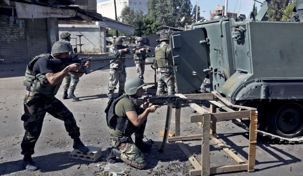 Lebanese army soldiers open fire during clashes with Islamic militants in the northern port city of Tripoli, Lebanon, on October 26, 2014. (AP Photo/Bilal Hussein)