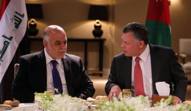 A handout picture made available by the Jordanian Royal Palace shows Jordan's King Abdullah II (R) meeting with Iraqi Prime Minister Haider Al-Abadi (L) at the Al-Husinea Royal Palace in Amman, Jordan, on October 26, 2014. (EPA/Jordanian Royal Palace/Handout)
