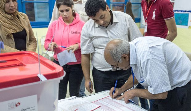 Tunisian election officials work during the count process at a polling station during the country's first post-revolution parliamentary election in Tunis, on October 26, 2014. (AP PHOTO/Aimen Zine)