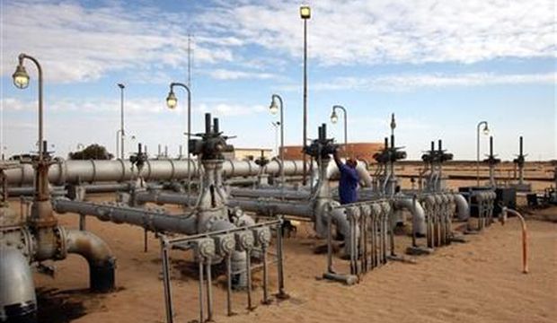 A worker checks pipes and valves at the Amaal oil field in eastern Libya, on October 7, 2011. (Reuters/Ismail Zitouny)