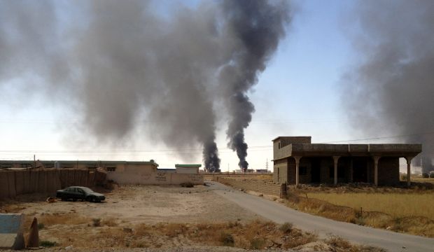 A picture made available on July 31, 2014, shows smoke rising from the Baiji oil refinery during the clashes between the fighters of Islamic State in Iraq and Syria (ISIS) and Iraqi forces in Baiji city, on July 30, 2014. (EPA)