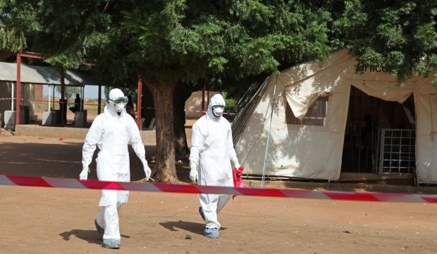 Health workers walk toward an area used for Ebola quarantine in Kayes, Mali, on October 25, 2014. (AP Photo/Baba Ahmed)