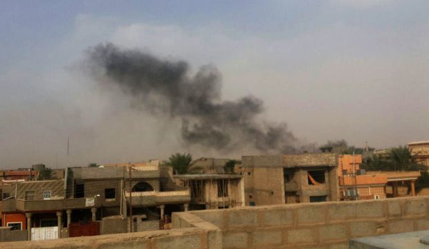 Smoke plumes are visible over buildings in the Iraqi town of Hit, in western Anbar province, 85 miles (140 km) west of Baghdad. (AP Photo) 