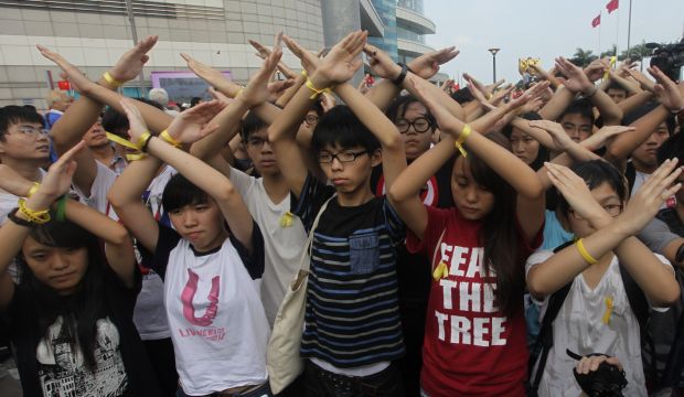 Scholarism founder Joshua Wong (C) and other members gesture during a flag-raising ceremony in Hong Kong on October 1, 2014, celebrating the 65th anniversary of China National Day. (Reuters/Stringer)