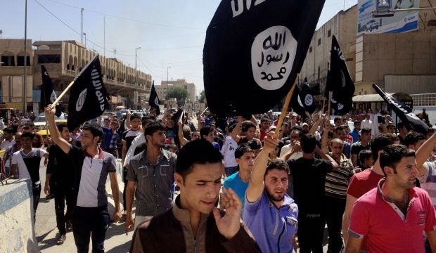 Demonstrators chant pro-ISIS slogans as they carry the group's flags in front of the provincial government headquarters in Mosul on June 16, 2014. (AP Photo, File)