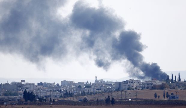 Smoke rises from the Syrian town of Kobani, seen from the Mursitpinar border crossing on the Turkish-Syrian border in the southeastern town of Suruc in Sanliurfa province, October 18, 2014. (Reuters)