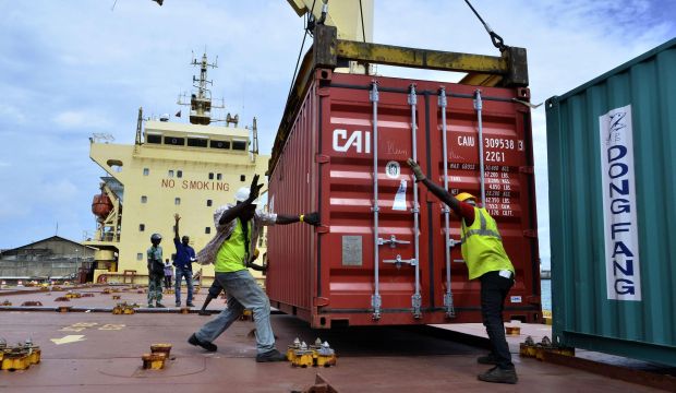 Workers move a container of rice destined for Monrovia and Freetown, both suffering from Ebola virus epidemics, at the port of Cotonou, Benin, on October 13, 2014. (Reuters/Charles Placide)