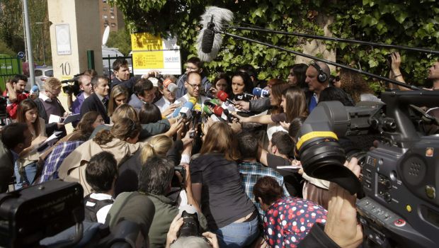 Journalists crowd around Deputy Director of La Paz-Carlos III hospital, Yolanda Fuentes (C-R), and Spanish doctor German Ramirez, a member of the team attending to Spanish nurse and Ebola patient Teresa Romero, in Madrid, Spain, on October 8, 2014. (EPA/Angel Diaz)
