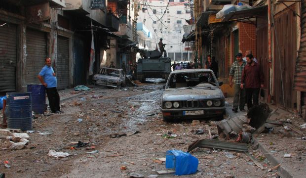Residents look at debris  following clashes between Lebanese soldiers and Islamist gunmen in Tripoli, northern Lebanon, on October 28, 2014. (Reuters/Omar Ibrahim)