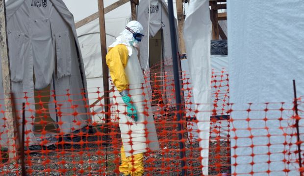 A health worker wearing Personal Protective Equipment (PPE) stands outside UNICEF tents at an Ebola treatment center run by the non-governmental international organization Medecins Sans Frontieres (Doctors without Borders -- MSF) in Monrovia, on October 27, 2014. (AFP)