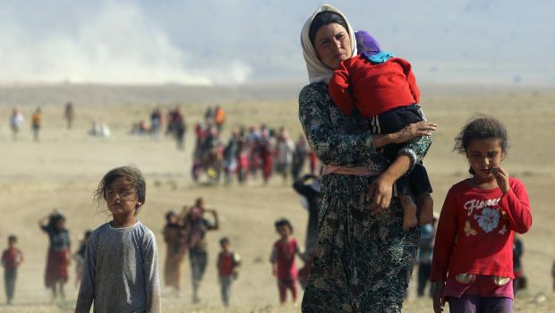 Displaced Yazidis, fleeing violence from forces loyal to the Islamic State of Iraq and Syria (ISIS) in Sinjar town, walk towards the Syrian border in August 11, 2014. (Reuters Photos.)