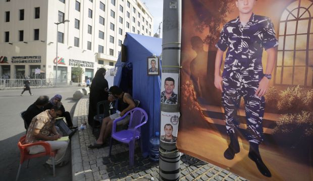 Relatives of Lebanese soldiers being held hostage in Syria by Islamist extremists stage a sit-in at the entrance of Lebanon's governmental palace in downtown Beirut in order to pressure the government to work on their release, on October 28, 2014. (AFP Photo/Joseph Eid)