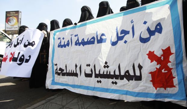 Protesters hold banners as they demonstrate against the deployment of armed militias of the Shi'ite Houthi movement in Yemeni cities, in Sana'a, Yemen, on November 1, 2014. (Reuters/Mohamed Al-Sayaghi)
