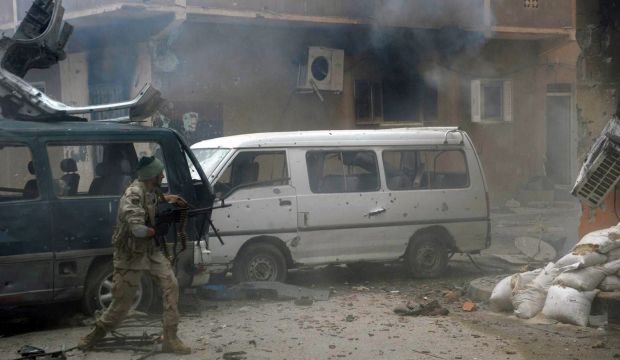 A member of the pro-government Libyan forces fires towards Islamist militiamen during clashes on November 2, 2014 in the Al-Salmani neighborhood of the the eastern coastal city of Benghazi. (AFP PHOTO / MOHAMED EL-SHEIKHI)
