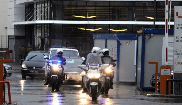 Police escort an ambulance believed to be carrying Algerian President Abdelaziz Bouteflika leaving the Grenoble Alembert clinic on November 15, 2015. (AFP Photo/Jean-Perre Clatot)