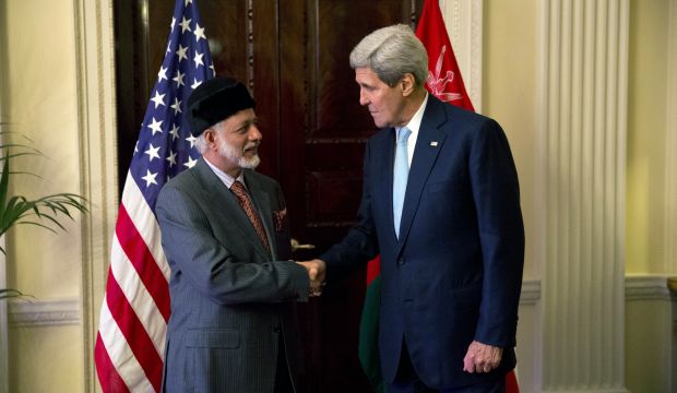 US Secretary of State John Kerry (R) and Oman Foreign Minister Yusuf Bin Alawi bin Abdullah (L) shake hands in the official residence of the US ambassador to Britain, in London on November 18, 2014. (AP Photo/Matt Dunham)