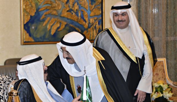 Kuwaiti Emir Sheikh Sabah Al-Ahmed Al-Jabir Al-Sabah (C) greets Saudi King Abdullah Bin Abdulaziz (seated) as the rulers of the Gulf Cooperation Council (GCC) member states met in an emergency session in Riyadh, Saudi Arabia, on November 16, 2014. (AP Photo/SPA)